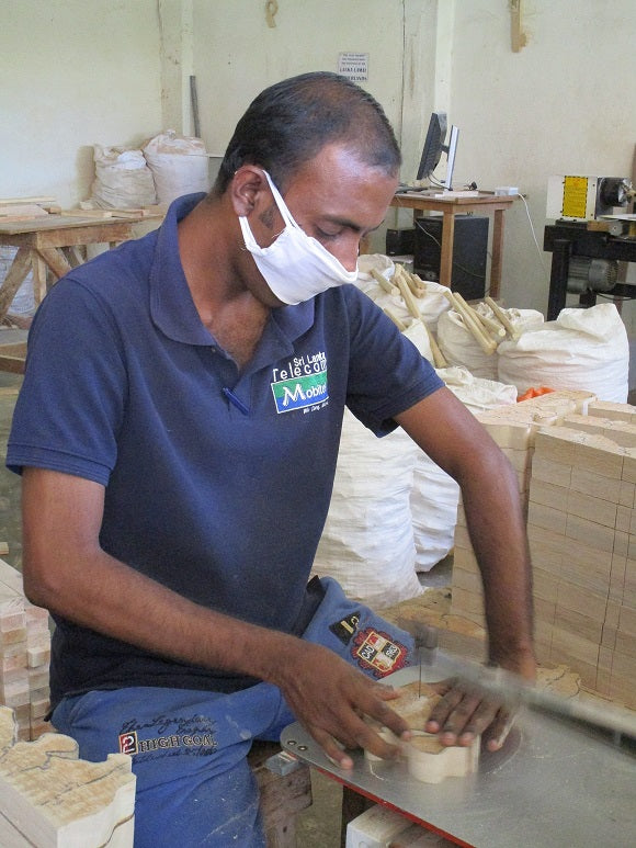 Educational rainbow wooden stacking Toy being handmade from a sustainable tree in Sri Lanka